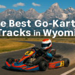 Featured image of a go-kart racing track in Wyoming with mountains in the background, showing a professional karting circuit with safety barriers and track markings